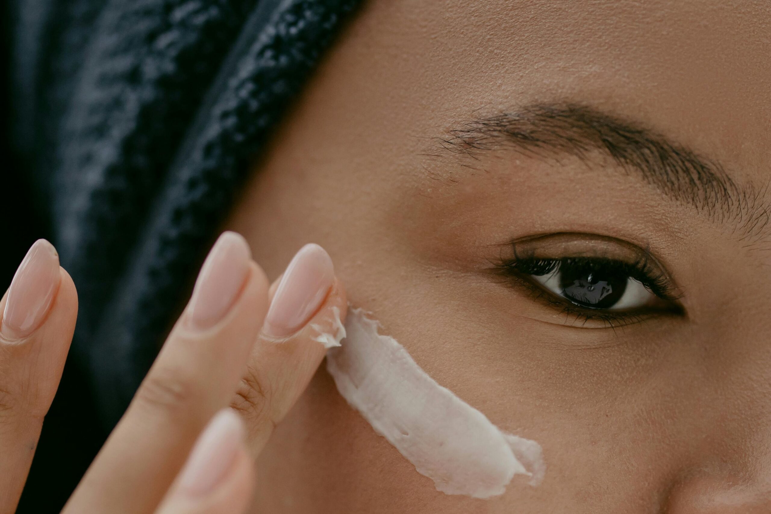 Close-up of a woman applying moisturizer before makeup