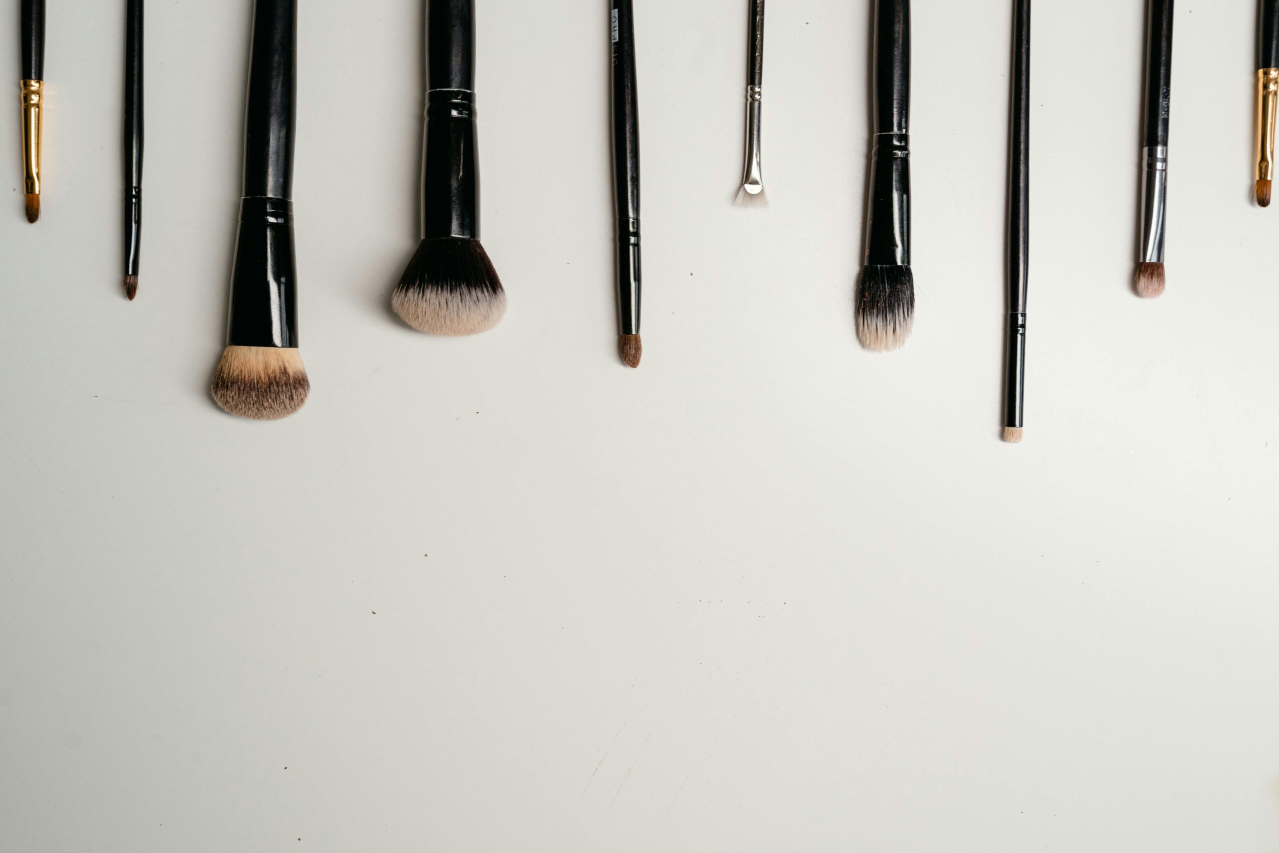 Set of professional-grade makeup brushes laid out neatly
