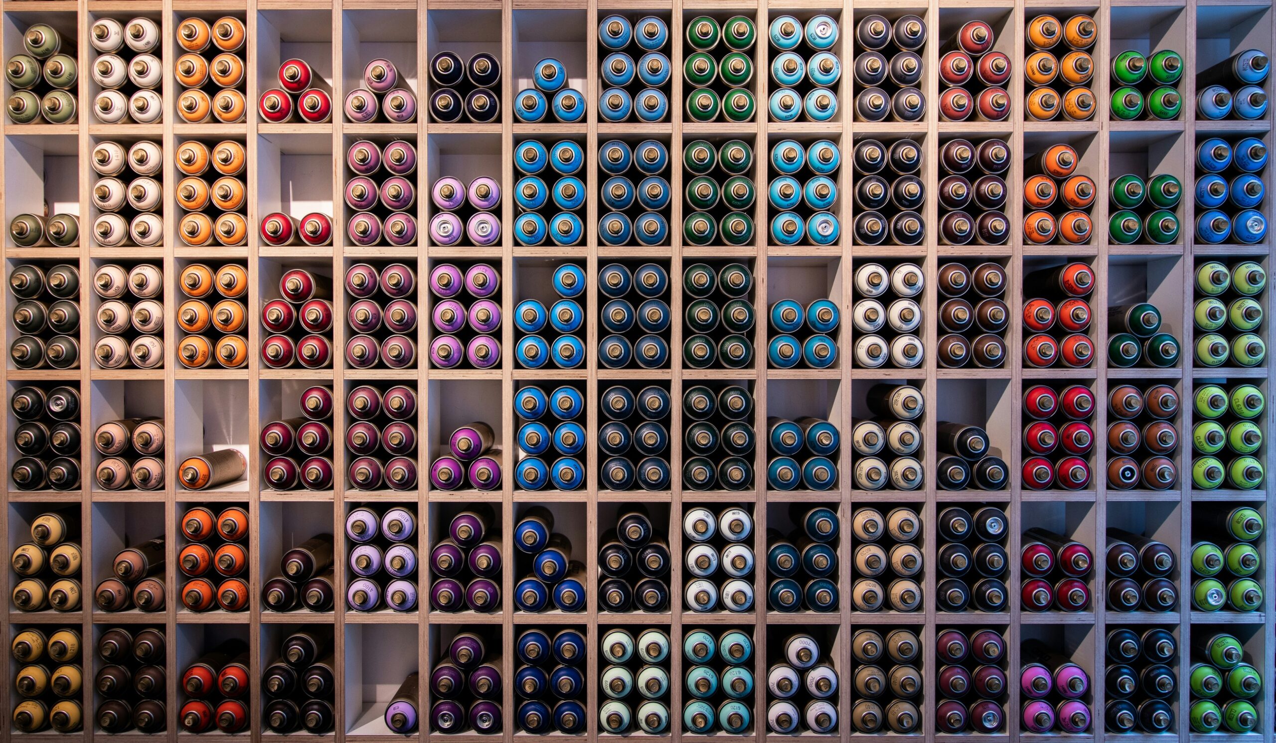 Rows of colorful drugstore makeup products stacked neatly on shelves