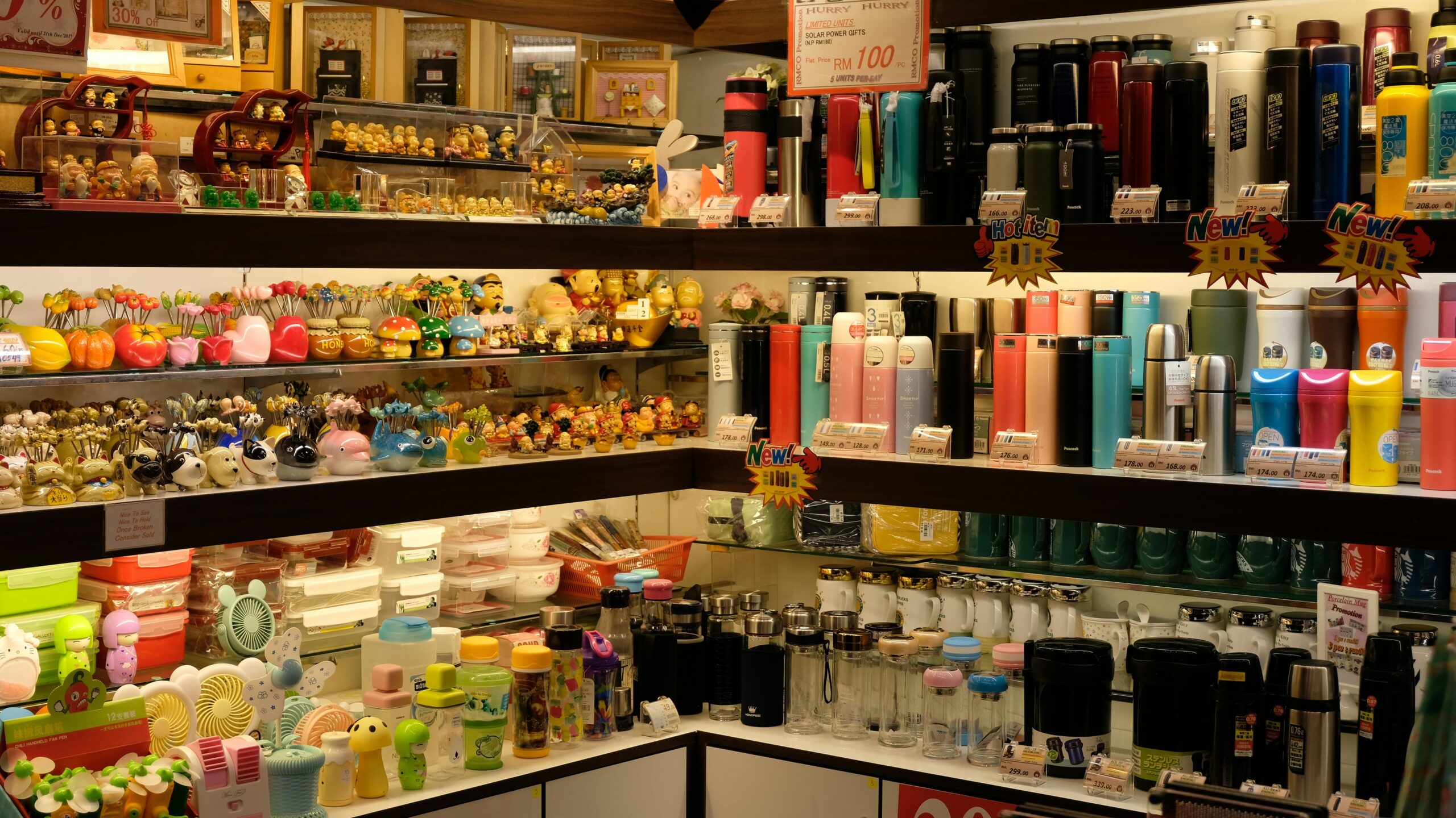 A row of colorful drugstore makeup products neatly arranged on a shelf