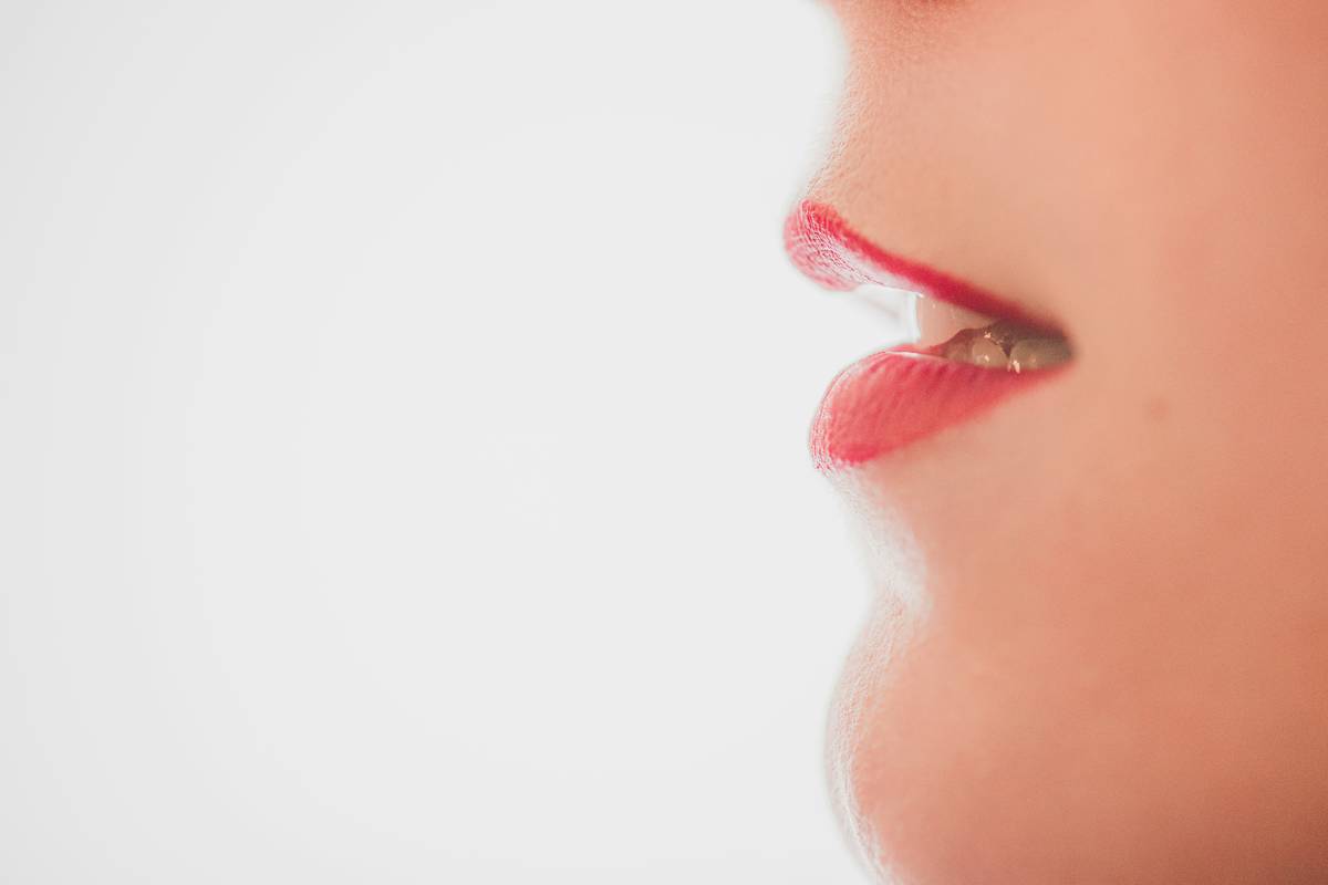 Close-up shot of someone applying lip balm with their finger