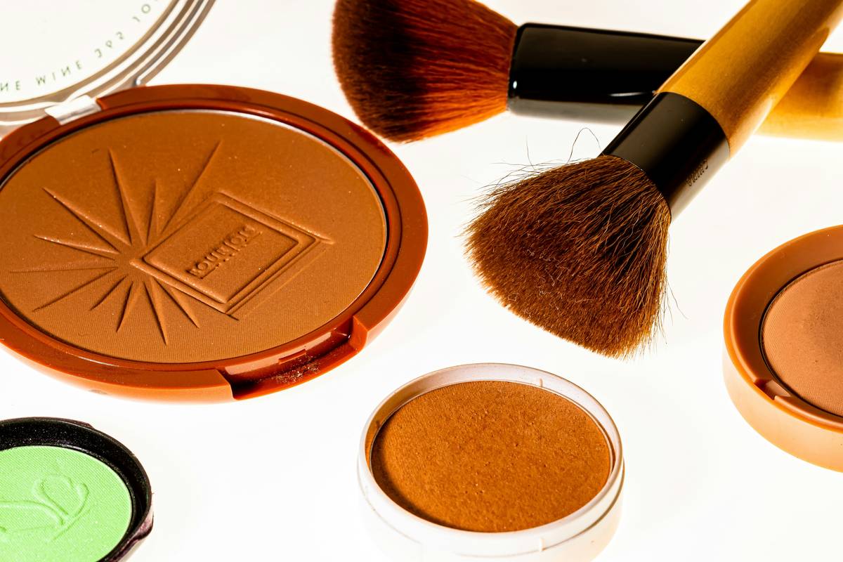 Closeup shot of the e.l.f. Baked Highlighter & Bronzer Duo compact swatched on a white surface