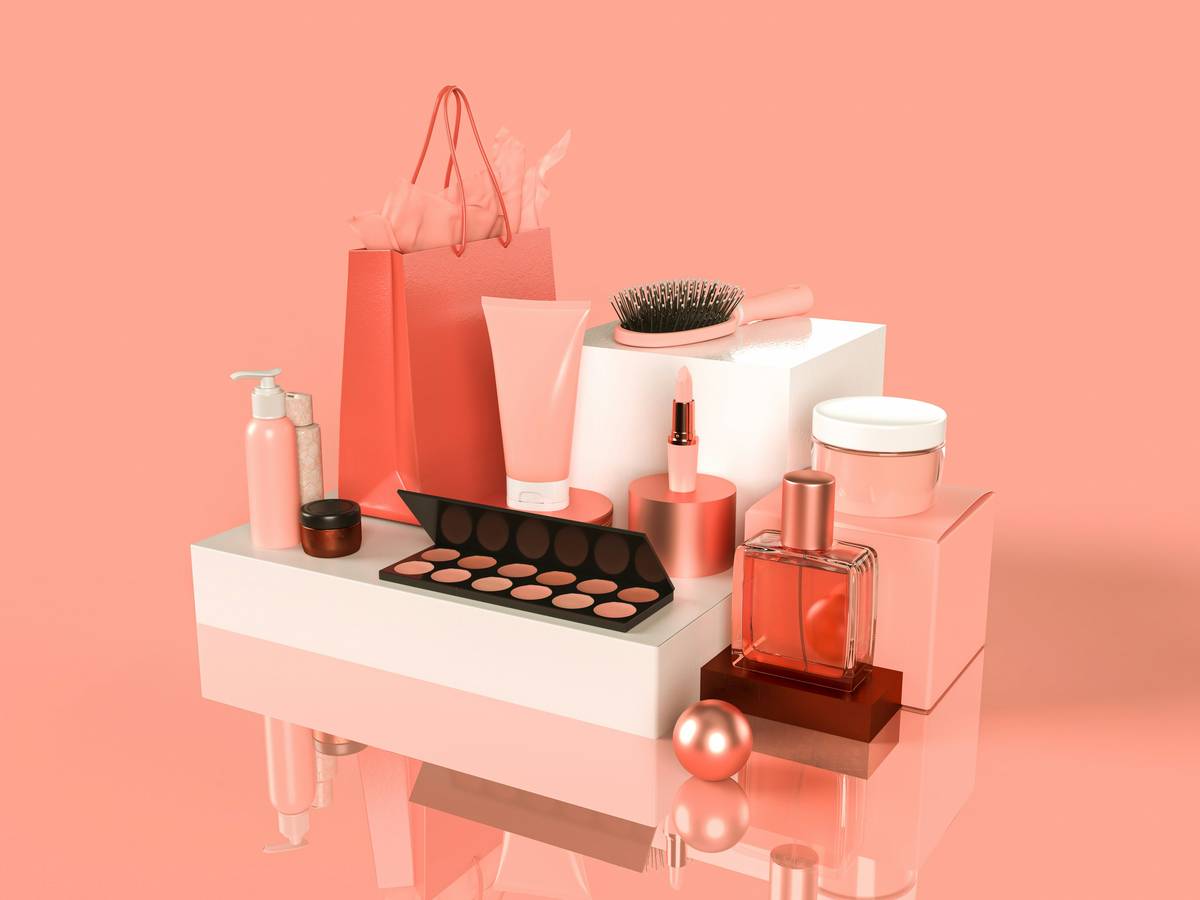 Display of affordable drugstore makeup products on a pink background