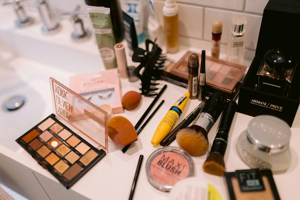 Makeup brushes laid out neatly on a wooden table.
