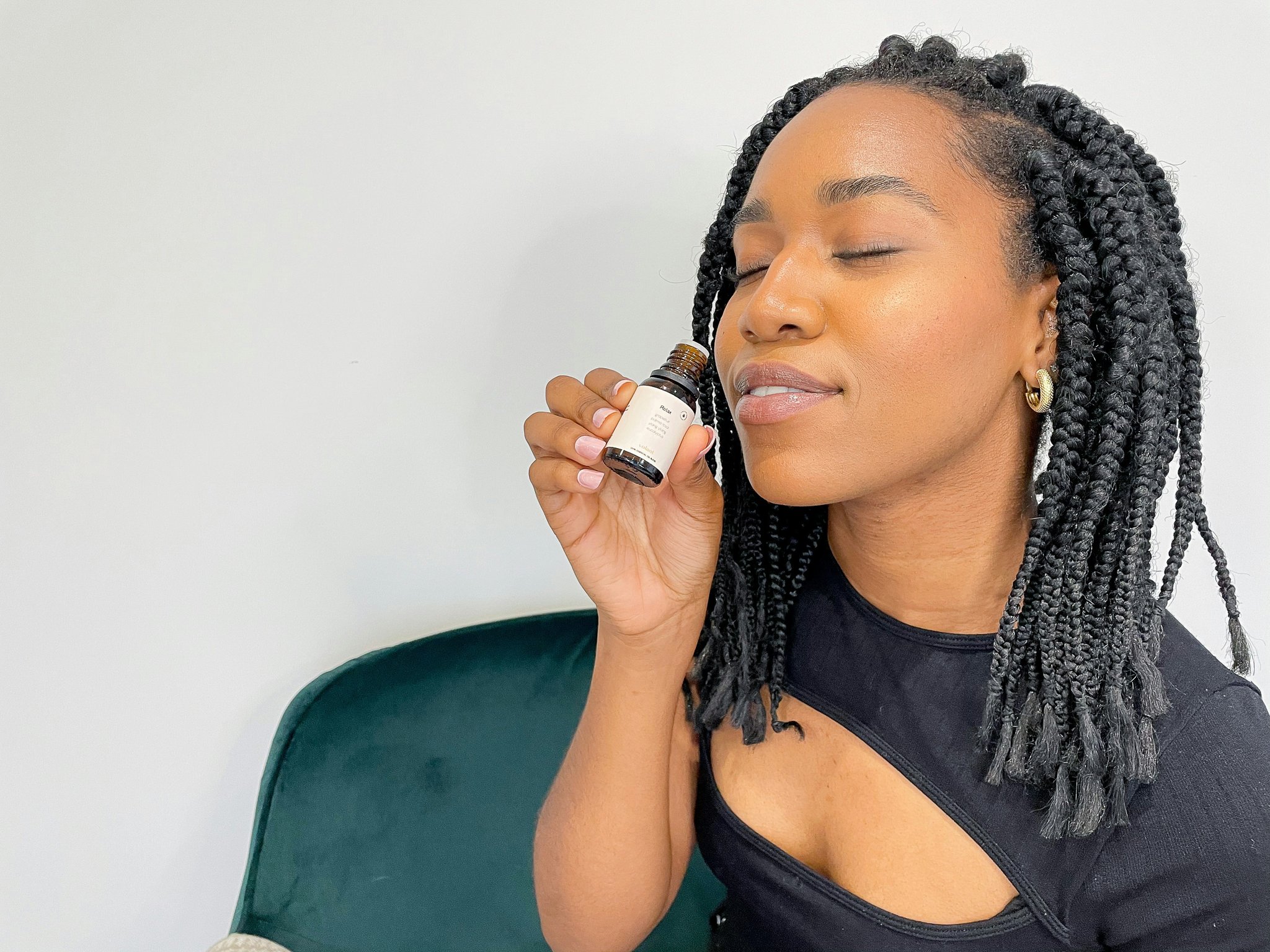 Woman holding affordable setting spray bottle with glowing complexion