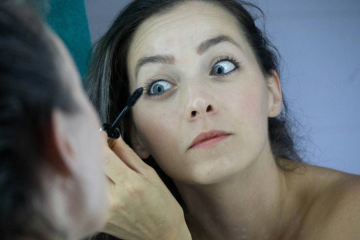 A close-up image showing rows of mascara wands at a drugstore counter.