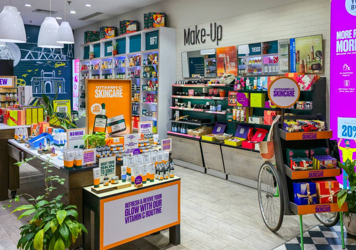 A collage of nine popular drugstore body lotions arranged neatly on a white background.